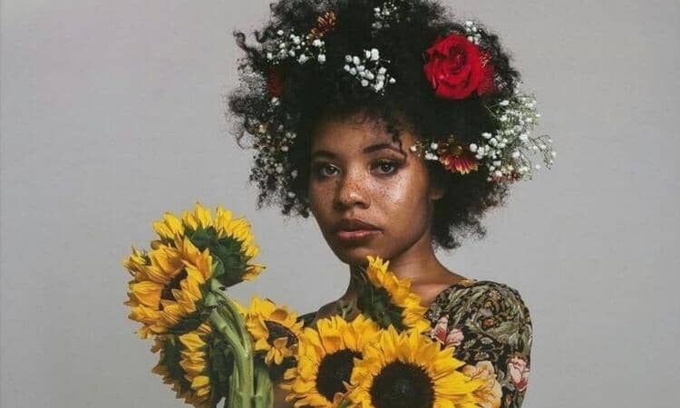 Afrocenchix Pretty Flower Hairstyles For Afro & Natural Hair: beautiful black woman with floral afro and sunflowers