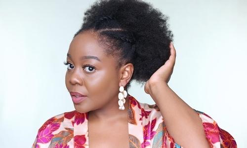 Beautiful black woman touching her afro hair