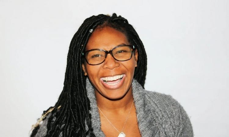 Afrocenchix article how menopause affects hair health: older black woman with glasses and braids laughing and smiling