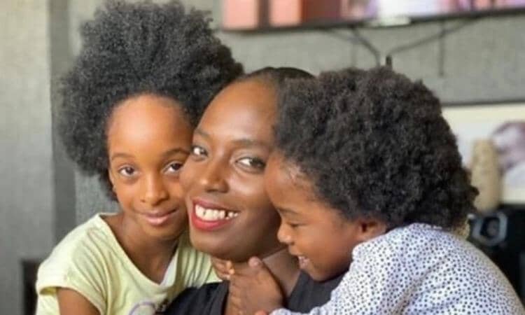 Afrocenchix essential Tips For Looking After Your Child’s Kinks, Coils & Curls: Happy black mum being cuddled by her two young children with natural hair