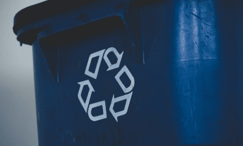 Close up of a Blue bin with the recycling symbol: 4 things you should know about recycling beauty products by Afrocenchix