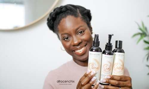 How To Halo Braid Natural Hair article: Beautiful black woman smiling holding Afrocenchix products