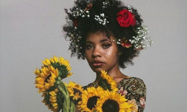 Afrocenchix Pretty Flower Hairstyles For Afro & Natural Hair: beautiful black woman with floral afro and sunflowers
