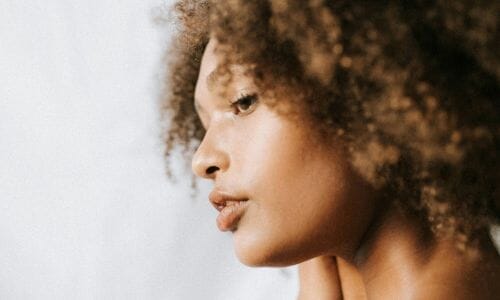Hair breakage: Young black woman with braids wearing glasses