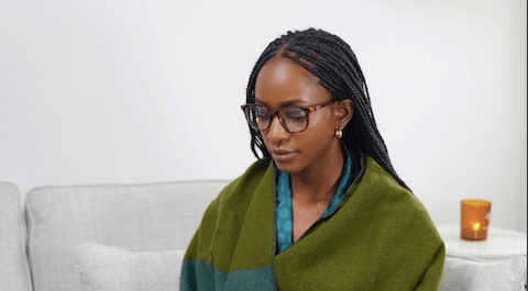 Professional Hairstyles for Black Women: woman with braids working on a laptop